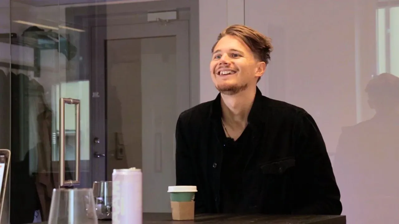David laughing at a table during the podcast recording