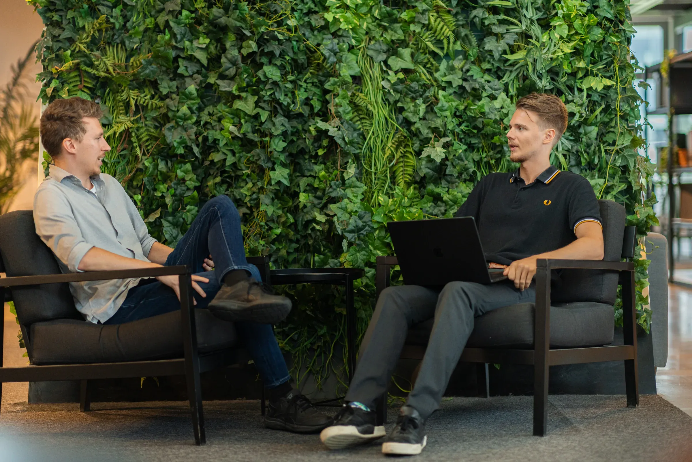 Philip and David talking by the green wall in the office, August 2024